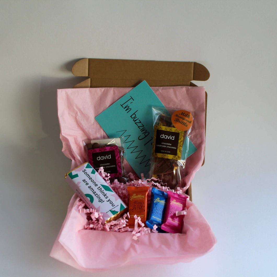 The chocolate box with pink tissue, O conaills 'someone thinks you are amazing' 50g milk chocolate bar, david's hot chocolate pellets, davids chocolate brittle, butlers mini chocolate bars