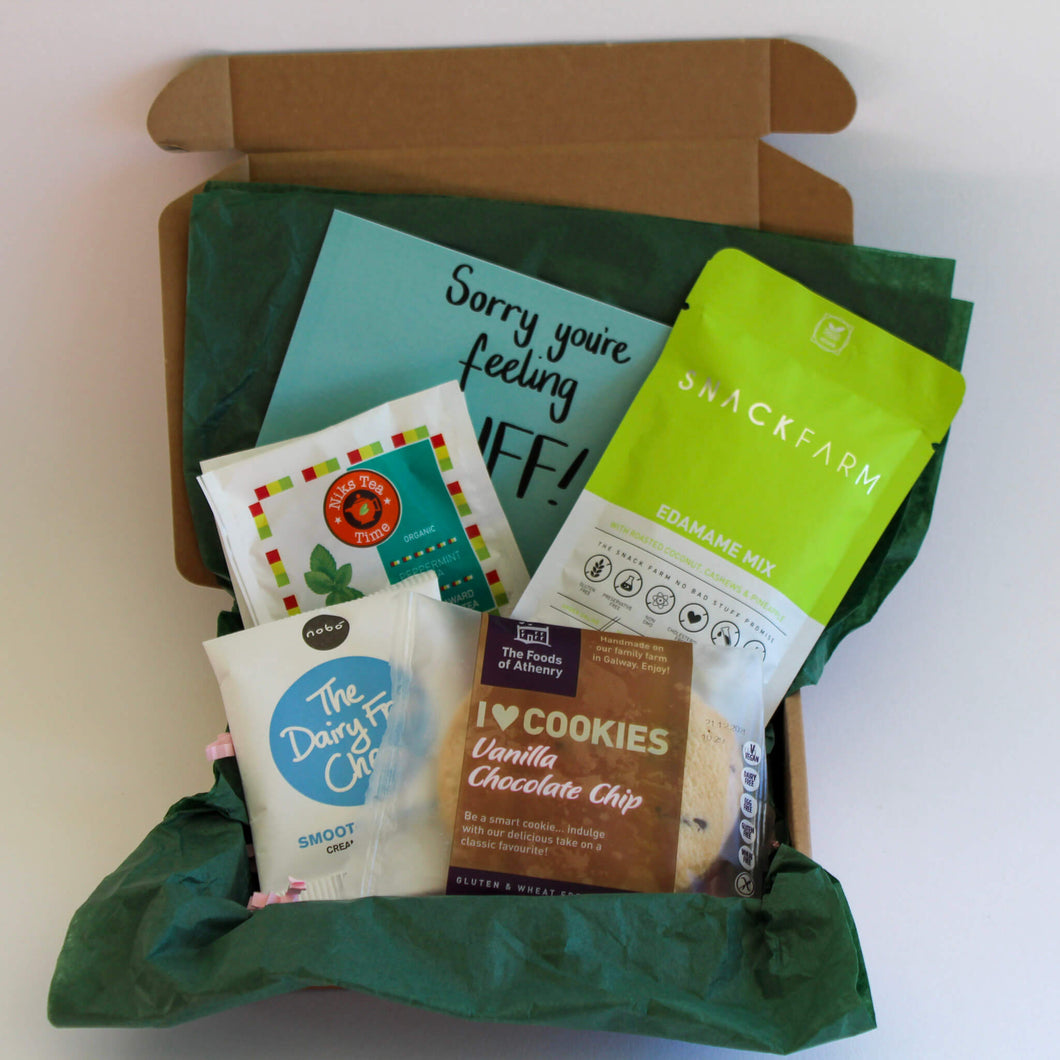 The Vegan Box with green tissue paper, snackfarm edamame mix, The Foods of Athenry Vanilla choc chip cookie, nobo smooth and creamy choc button and Niks tea in Peppermint and Berry